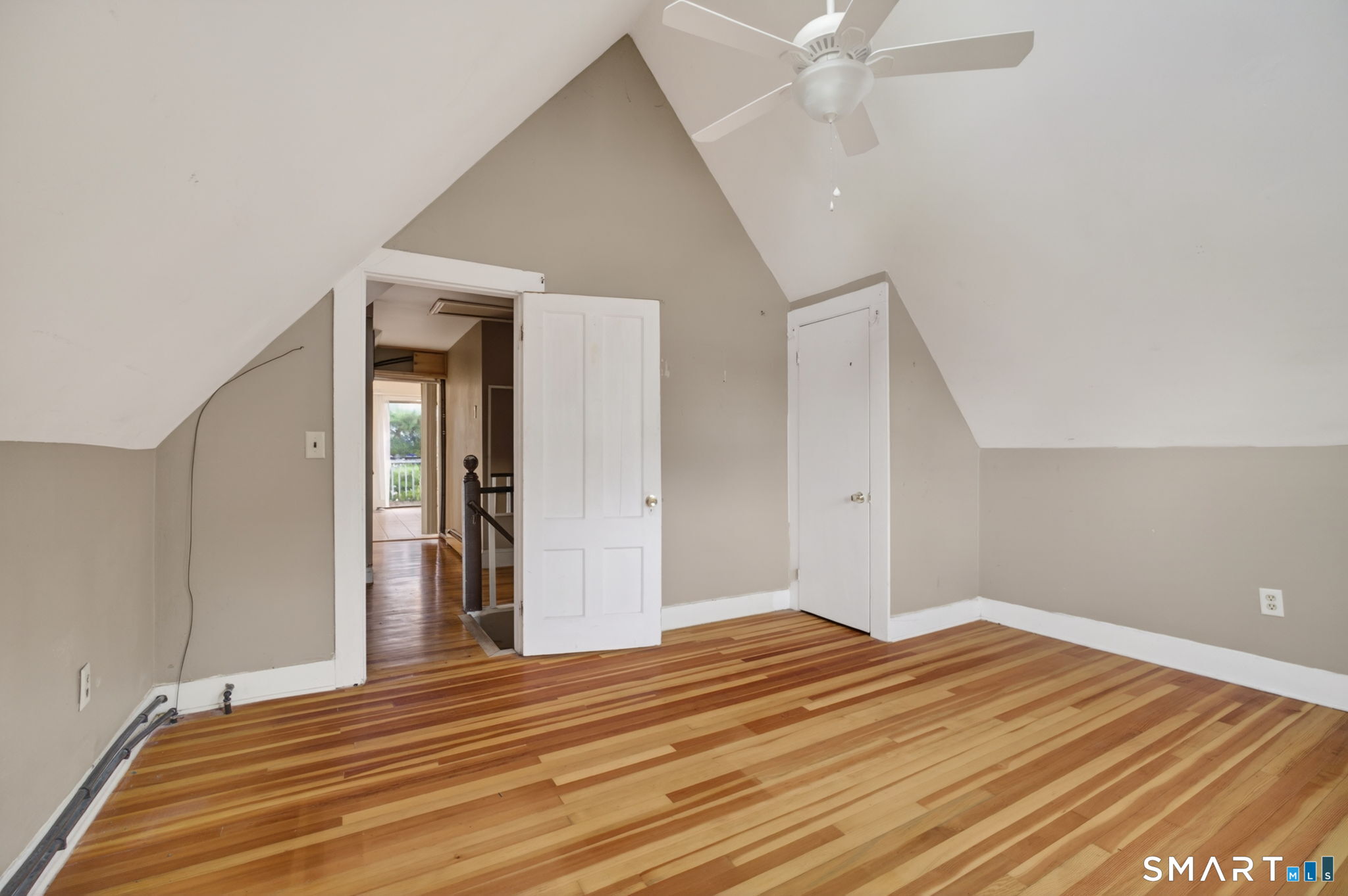 670 Hanover Road Meriden, CT 06451 - Photo 39 of 40 a view of a livingroom with wooden floor and a ceiling fan