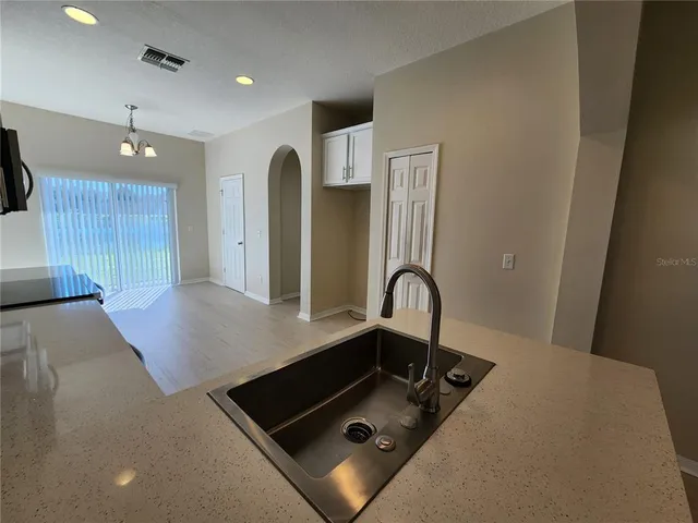 a room with pool table and glass windows