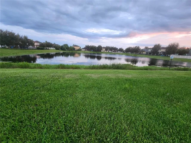 a view of a lake with houses in the back