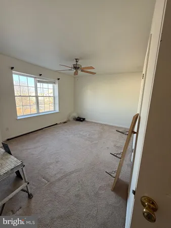 a view of an empty room and a window