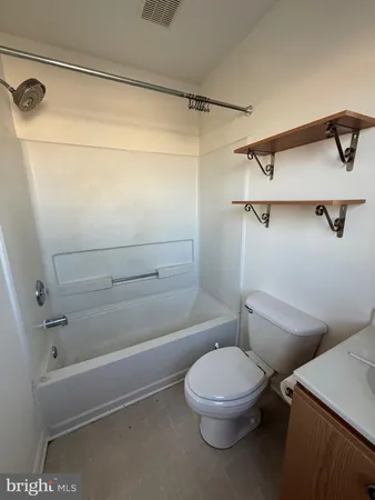 a bathroom with a toilet a sink and bathtub