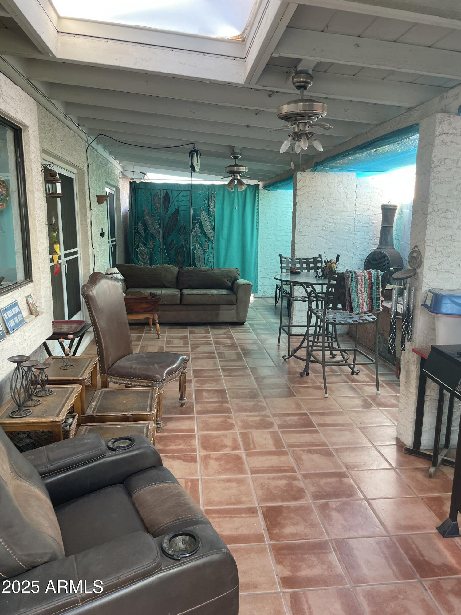 1022 East Wagoner Road Phoenix, AZ 85022 - Photo 12 of 13 a outdoor space with lots of tables a chairs a rug and a potted plant