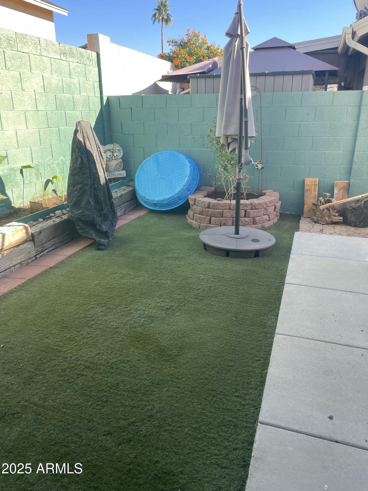 1022 East Wagoner Road Phoenix, AZ 85022 - Photo 13 of 13 a view of a chairs and table in backyard