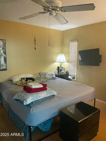 a bedroom with a bed and a chandelier