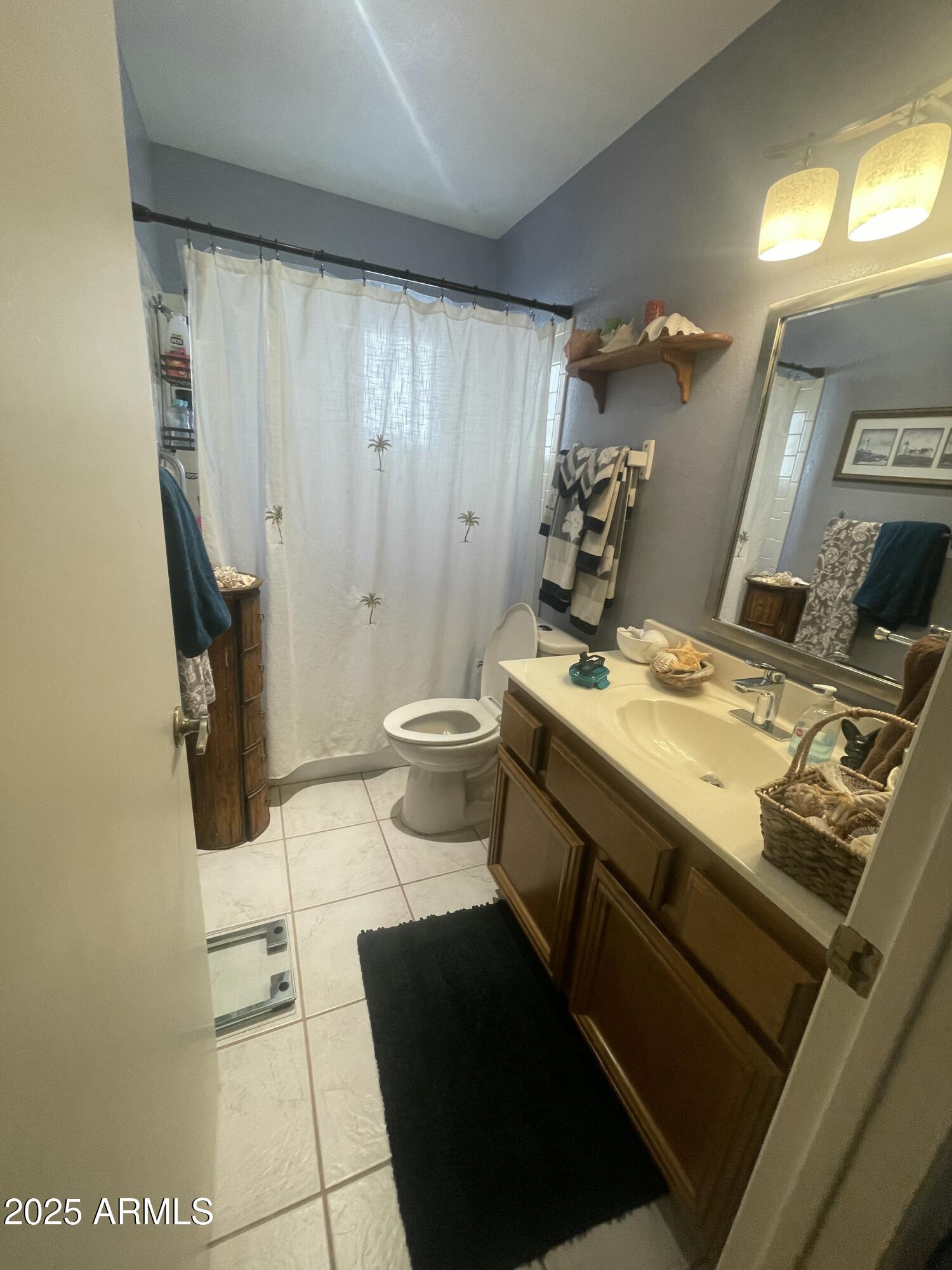 1022 East Wagoner Road Phoenix, AZ 85022 - Photo 8 of 13 a bathroom with a sink and a mirror