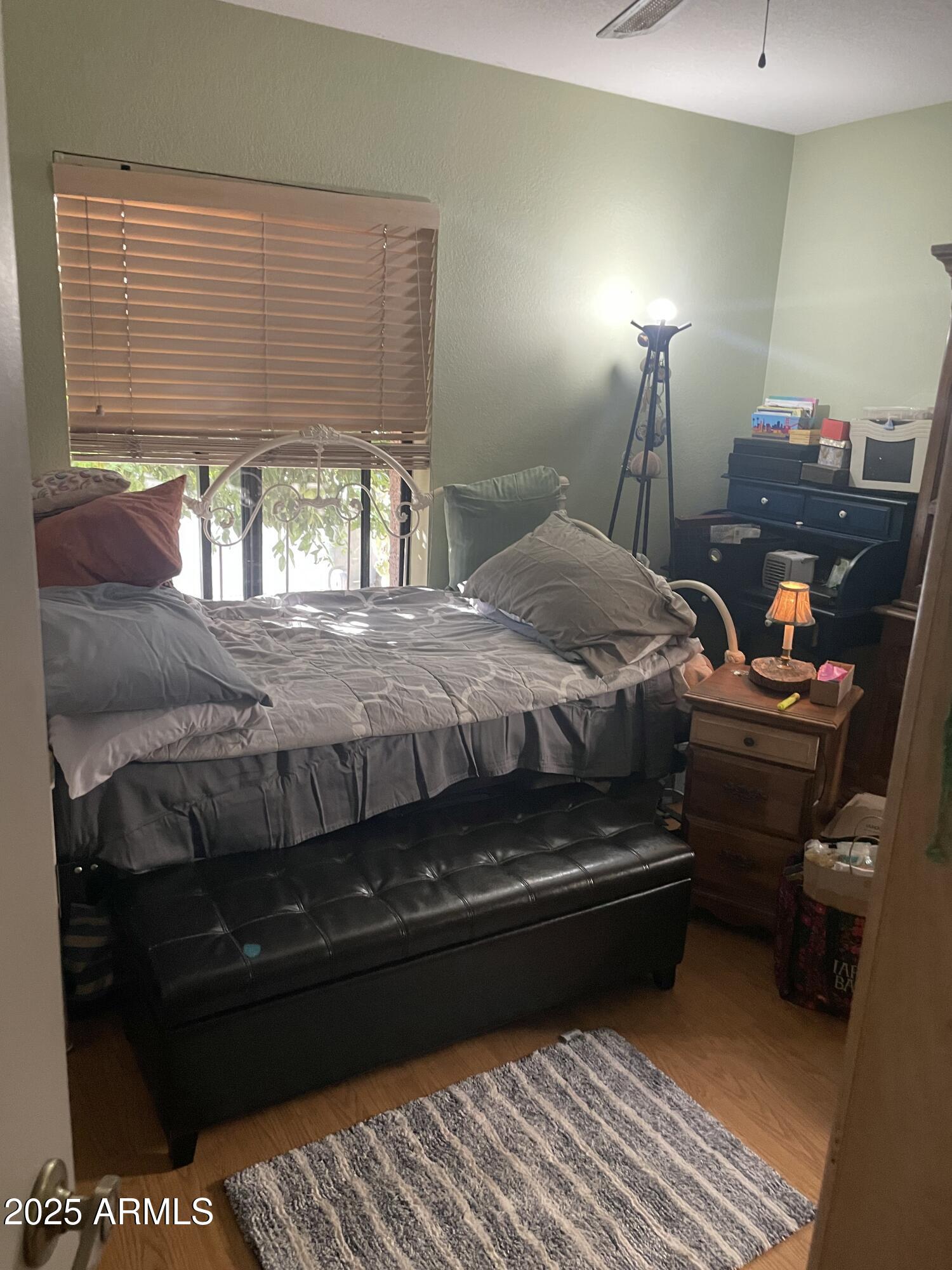 1022 East Wagoner Road Phoenix, AZ 85022 - Photo 9 of 13 a bedroom with a bed window and lamp