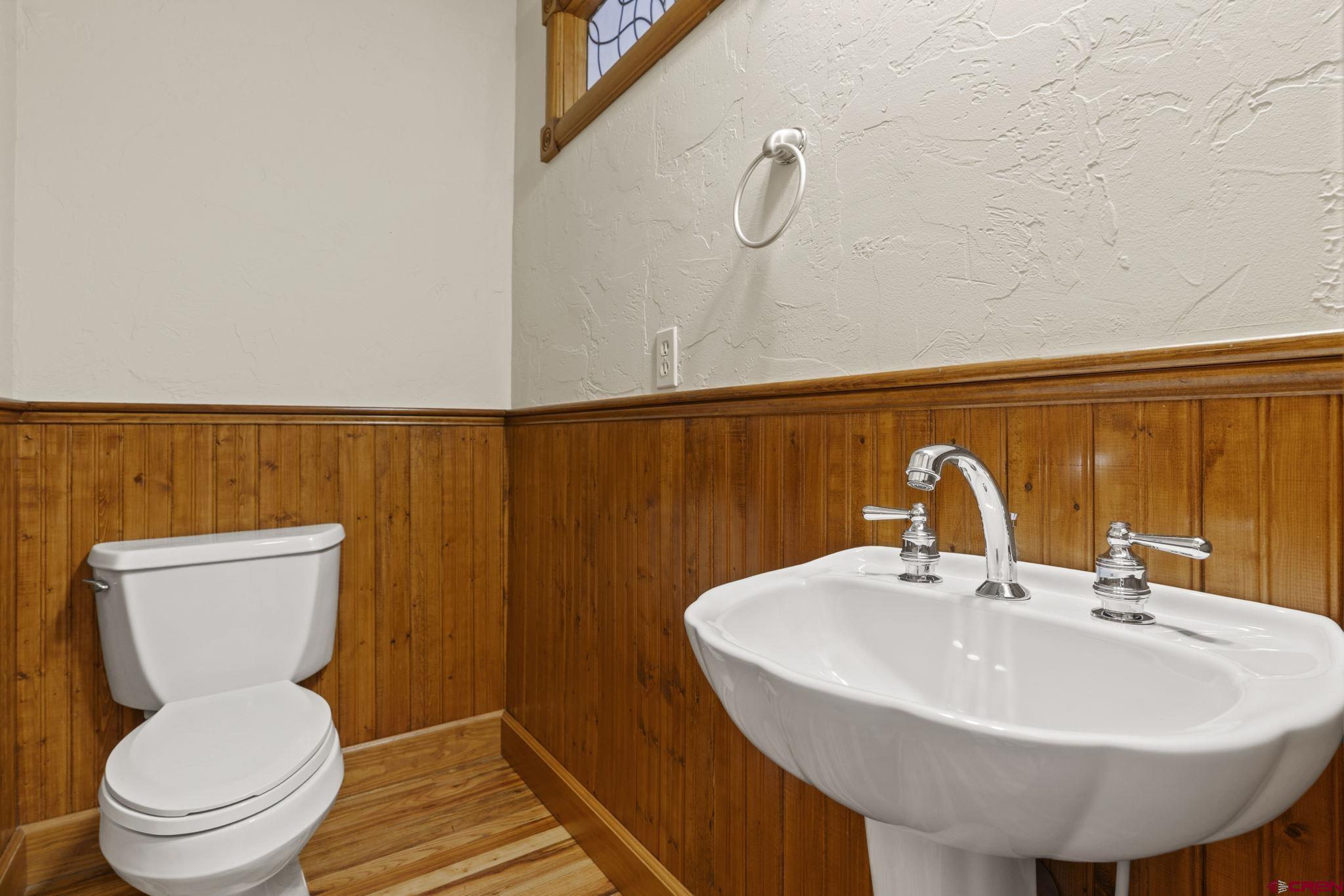 1330 East 3rd Avenue Durango, CO 81301 - Photo 11 of 32 a bathroom with a sink a toilet and a mirror
