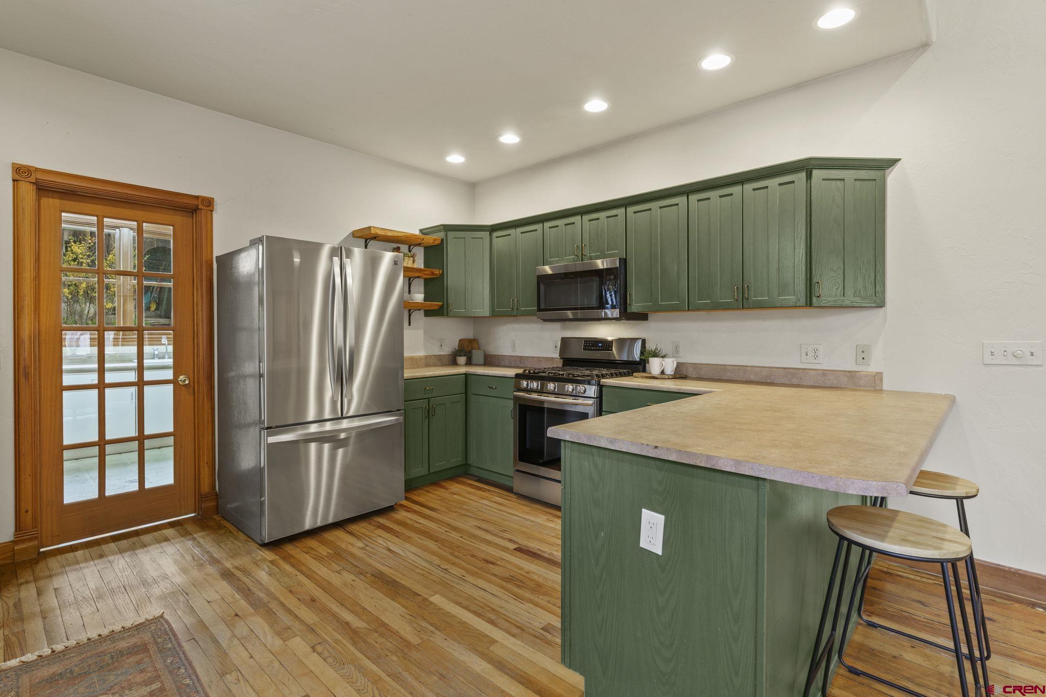1330 East 3rd Avenue Durango, CO 81301 - Photo 14 of 32 a kitchen with stainless steel appliances granite countertop a refrigerator stove and microwave
