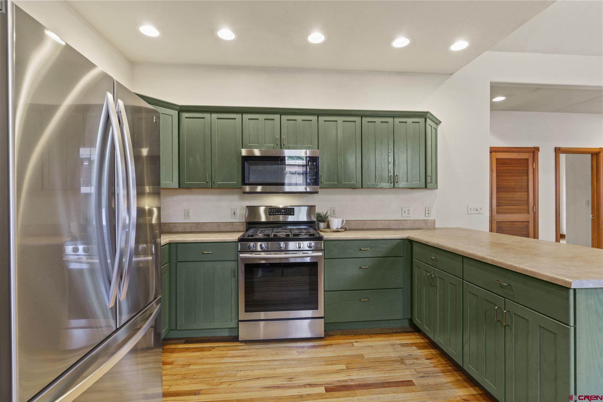 1330 East 3rd Avenue Durango, CO 81301 - Photo 16 of 32 a kitchen with stainless steel appliances granite countertop a refrigerator and a sink
