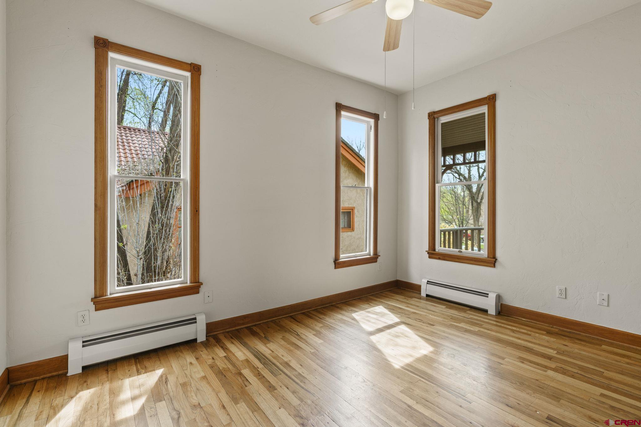 1330 East 3rd Avenue Durango, CO 81301 - Photo 19 of 32 a view of an empty room with window and wooden floor