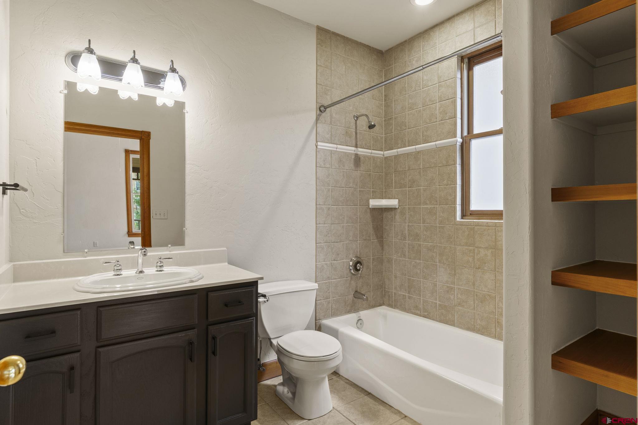 1330 East 3rd Avenue Durango, CO 81301 - Photo 20 of 32 a bathroom with a sink a toilet and shower