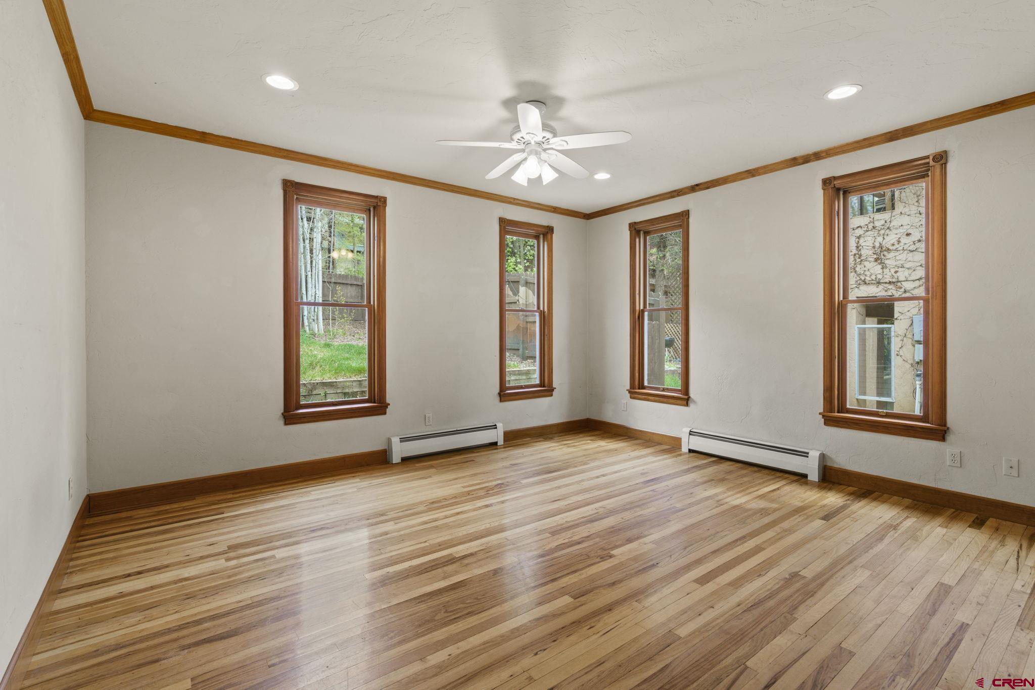 1330 East 3rd Avenue Durango, CO 81301 - Photo 23 of 32 a view of an empty room with window and wooden floor