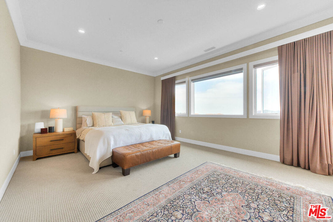 20558 Overlook Court Porter Ranch, CA 91326 - Photo 18 of 48 a spacious bedroom with a bed and a couch