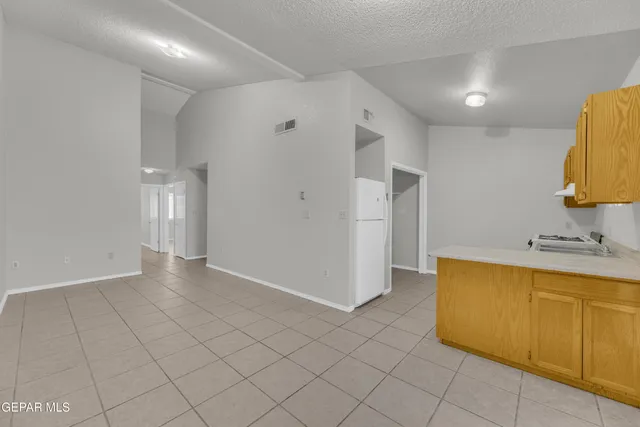 a kitchen that has a sink and a stove in it