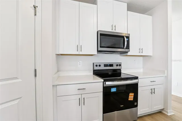 a kitchen with a stove and a microwave