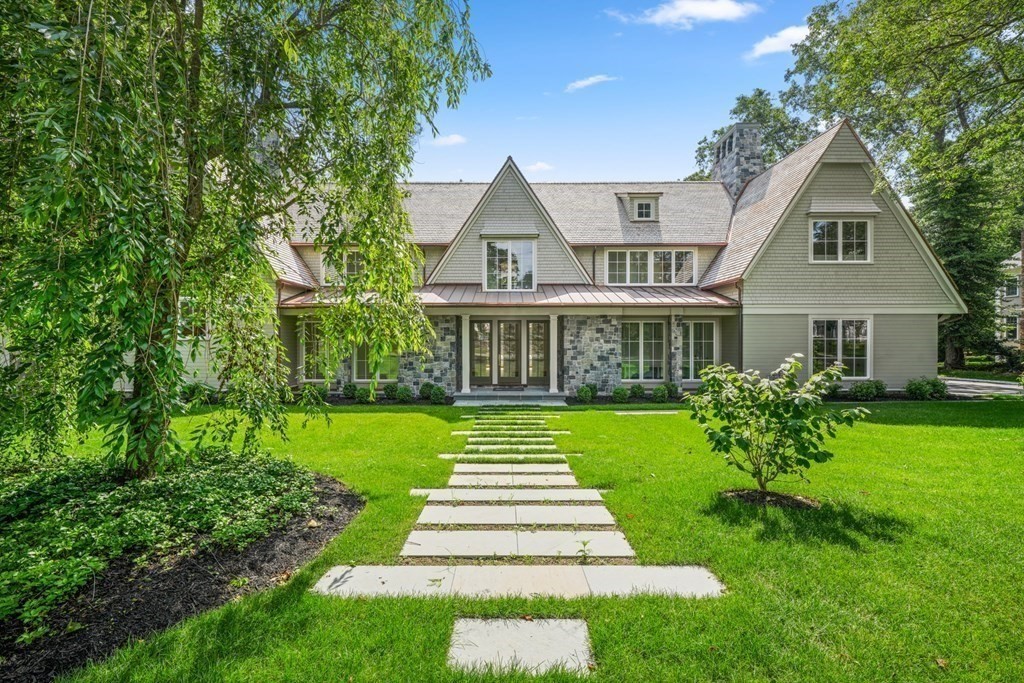 a front view of a house with a yard table and chairs