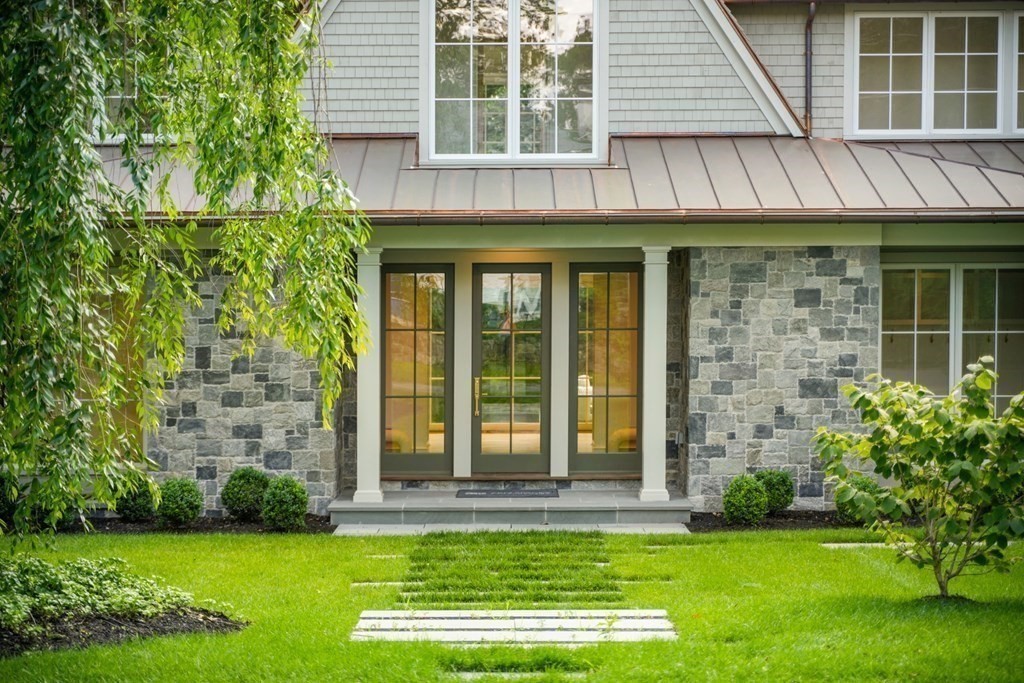 78 Arnold Road Wellesley, MA 02481 - Photo 2 of 42 a view of a brick house with a large windows and a yard