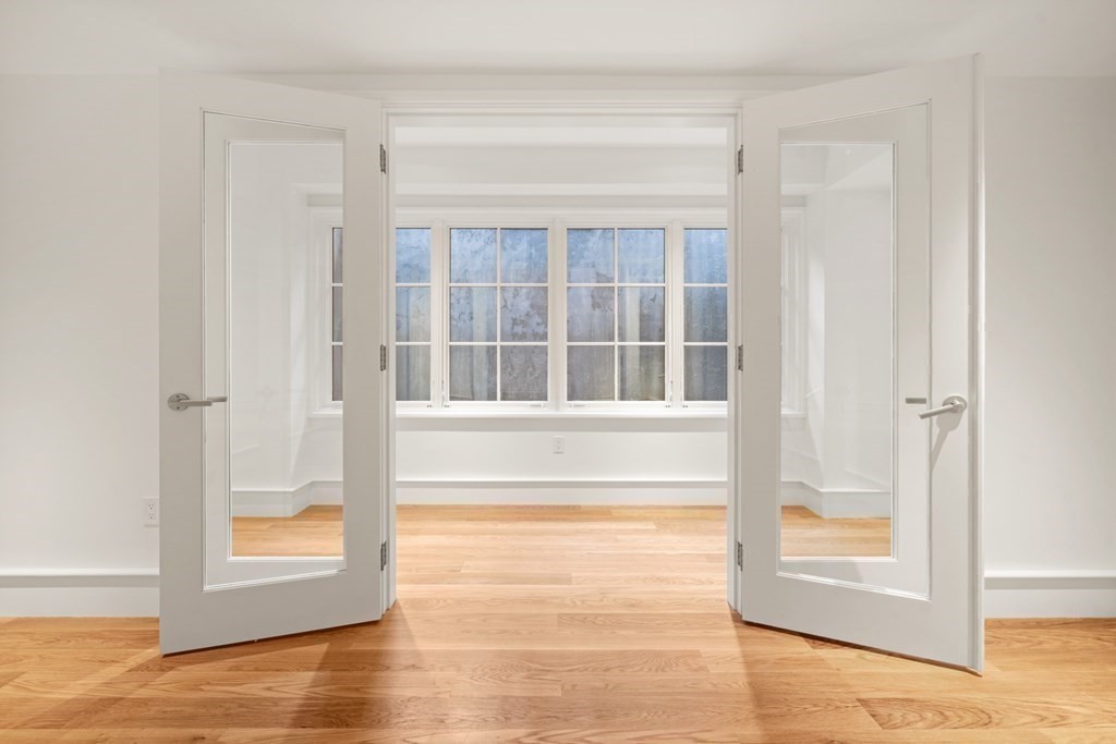 78 Arnold Road Wellesley, MA 02481 - Photo 32 of 42 a view of an empty room with wooden floor and a window