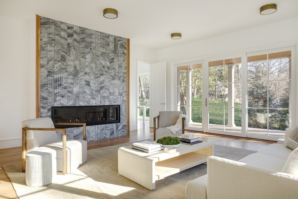 78 Arnold Road Wellesley, MA 02481 - Photo 4 of 42 a living room with furniture a large window and a fireplace