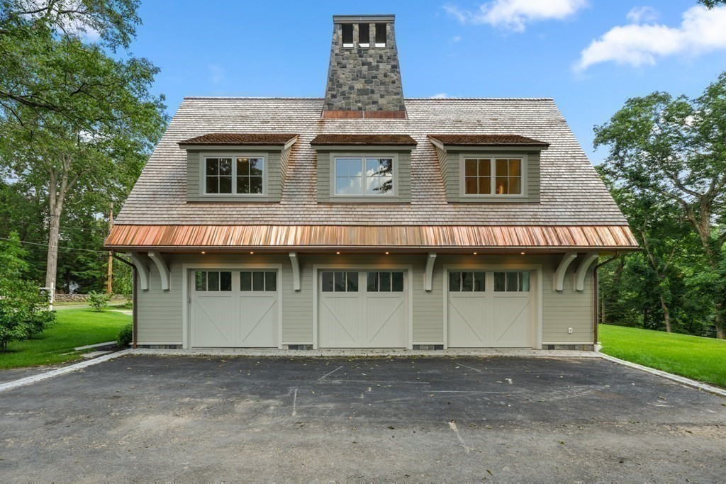78 Arnold Road Wellesley, MA 02481 - Photo 41 of 42 a view of a white house with a large window and large tree