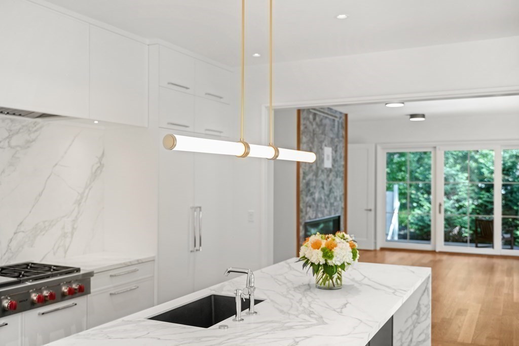 78 Arnold Road Wellesley, MA 02481 - Photo 9 of 42 a bathroom with a granite countertop sink a bathtub and a window