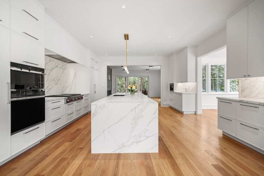 78 Arnold Road Wellesley, MA 02481 - Photo 10 of 42 a large white kitchen with a stove a sink dishwasher and a oven with wooden floor