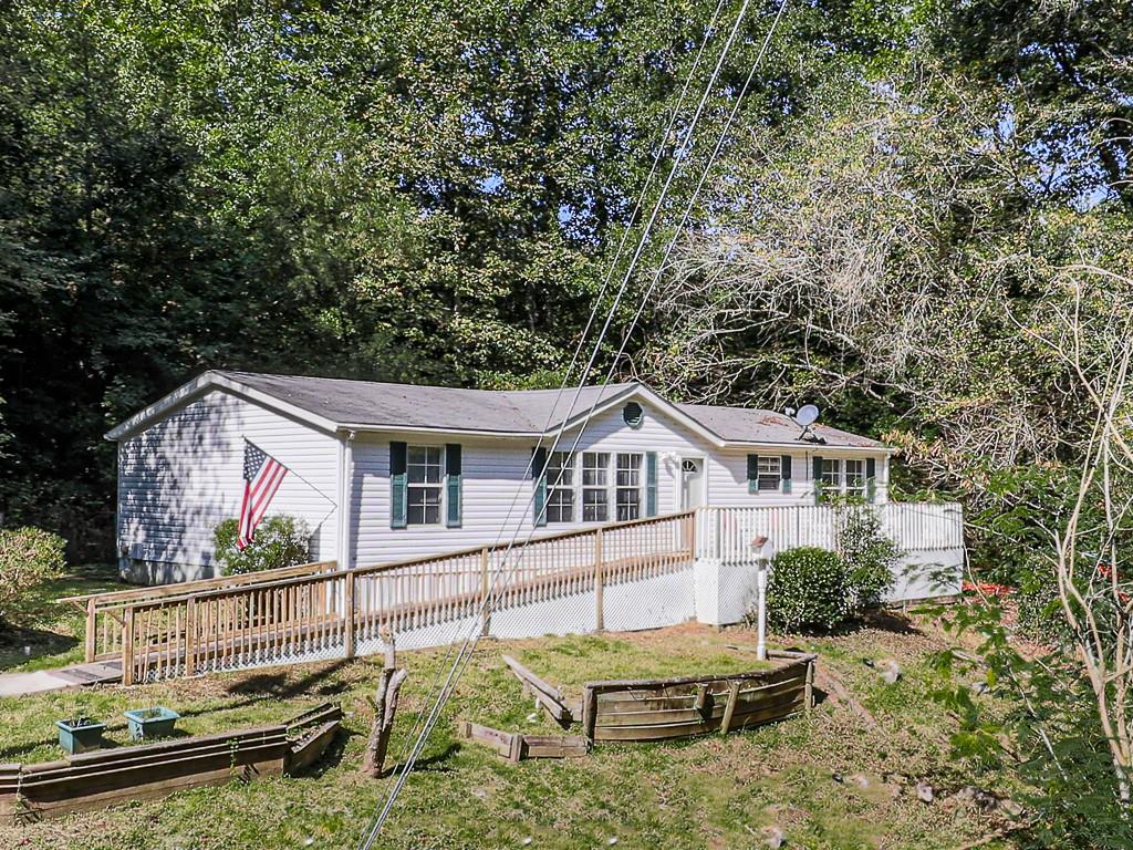 681 Lower Scott Mill Road Canton, GA 30115 - Photo 1 of 1 a view of a house with a yard and furniture
