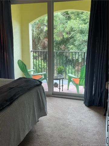 a view of a dining room with furniture and a window
