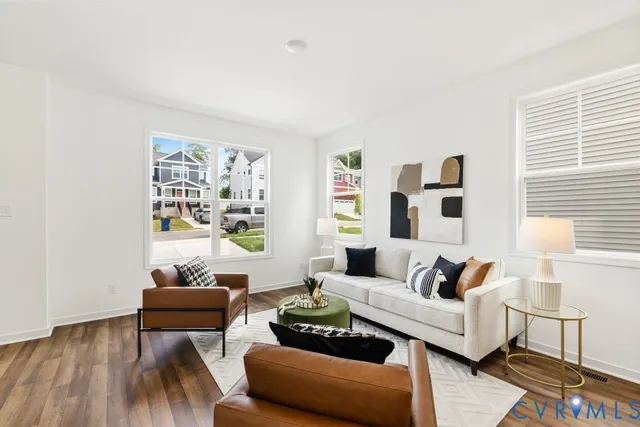 a living room with furniture and wooden floor