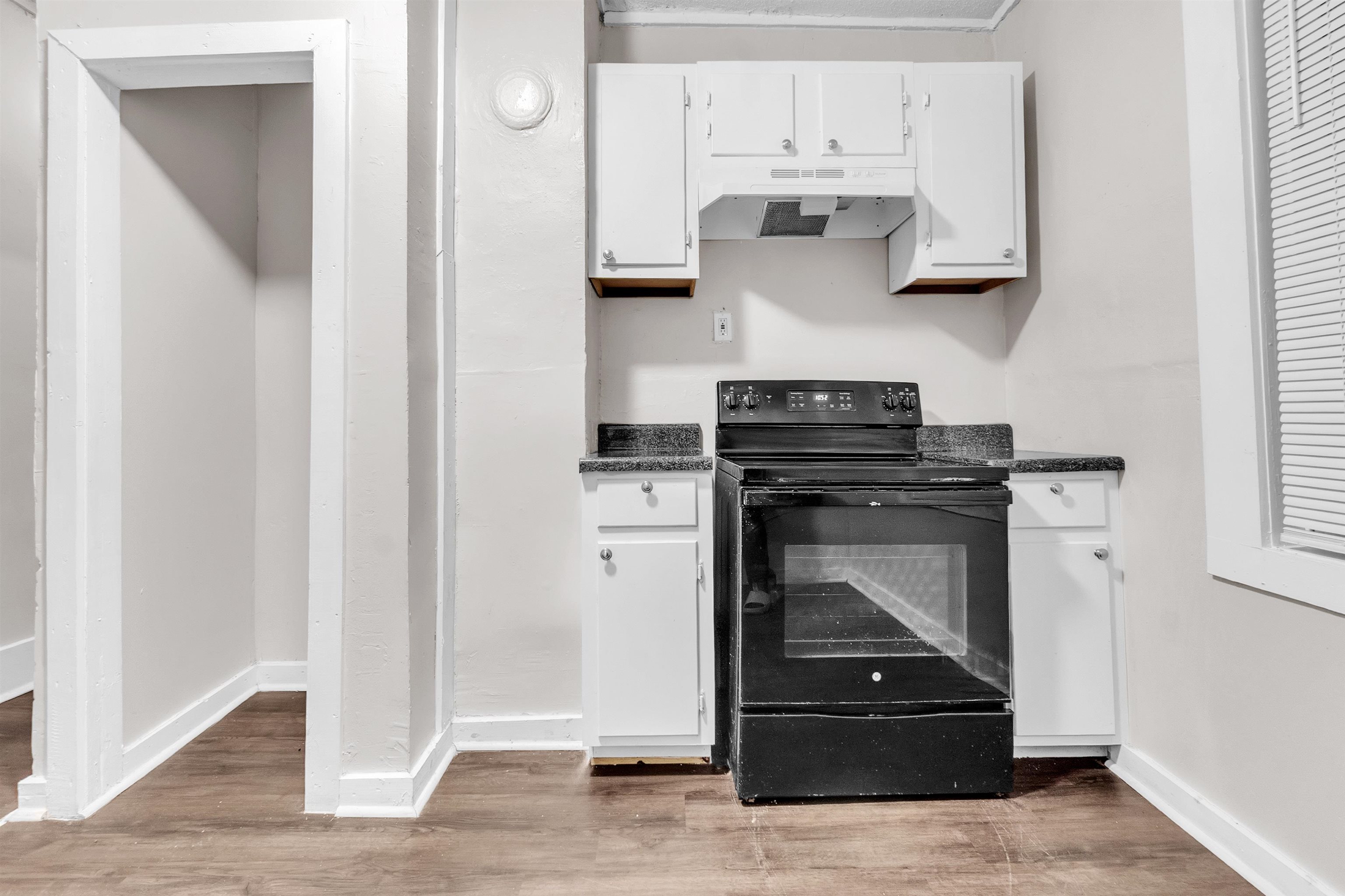 689 Baltimore Street Memphis, TN 38114 - Photo 13 of 14 a kitchen with white cabinets and appliances