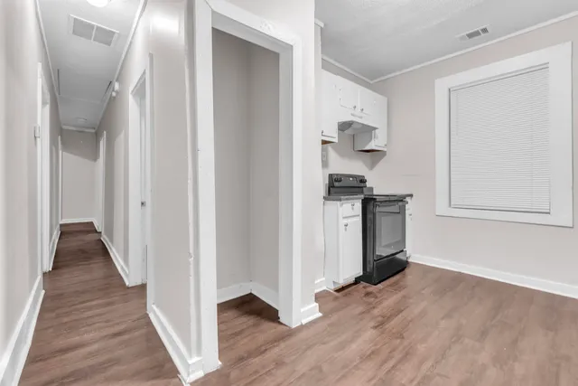 a view of hallway with wooden floor