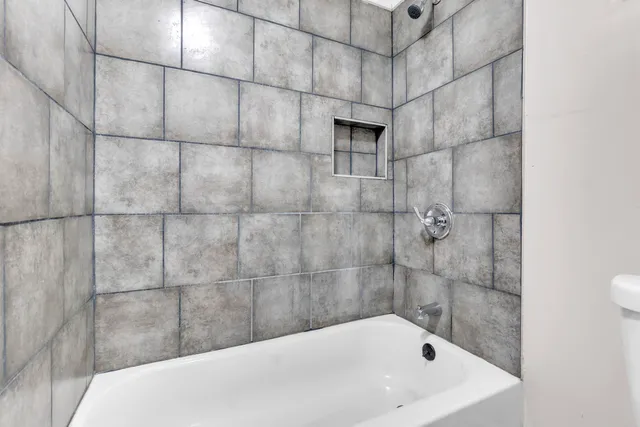 a bathroom with a bathtub and shower