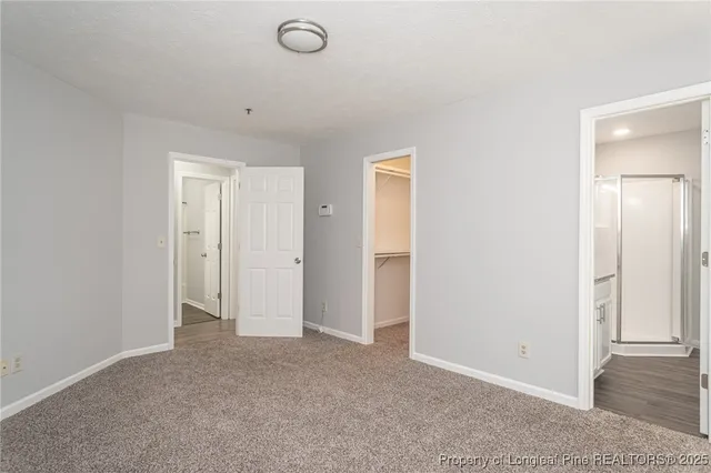 a view of an empty room and closet area
