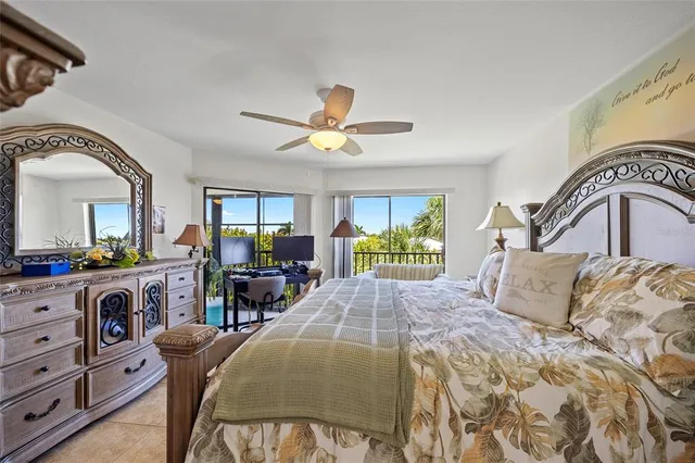 a bedroom with a bed and ceiling fan