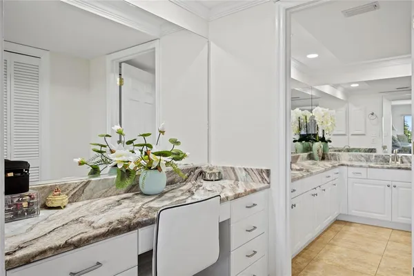 a kitchen with sink and white cabinets