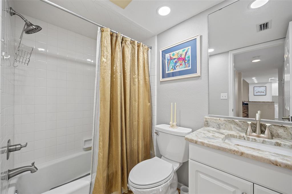 601 Shreve Street, Unit 53C Punta Gorda, FL 33950 - Photo 17 of 30 a bathroom with a granite countertop sink toilet and shower