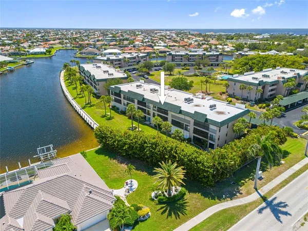 an aerial view of a house with a swimming pool outdoor seating and yard