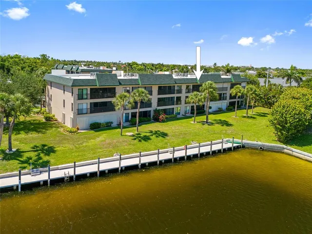 a view of a swimming pool with lawn chairs