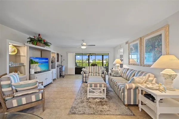 a living room with furniture large window and a flat screen tv
