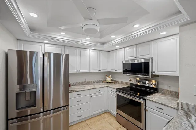 a kitchen with appliances a sink and cabinets