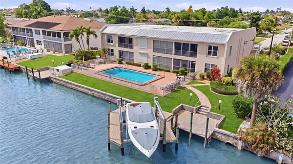 an aerial view of a house with pool and chairs