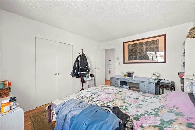 a bedroom that has a bed and a dresser in it