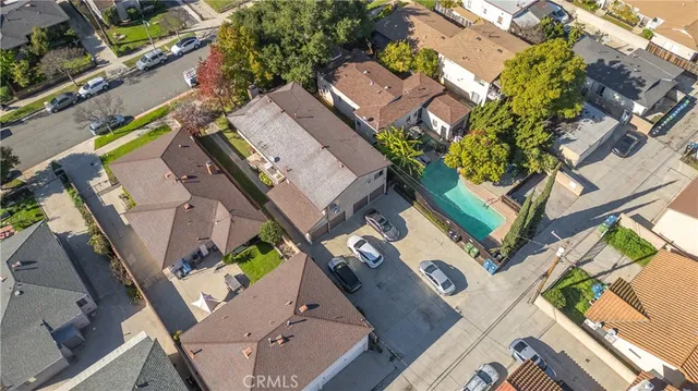 an aerial view of residential house with outdoor space and swimming pool