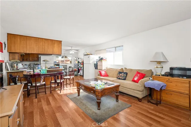 a living room with furniture and a kitchen view