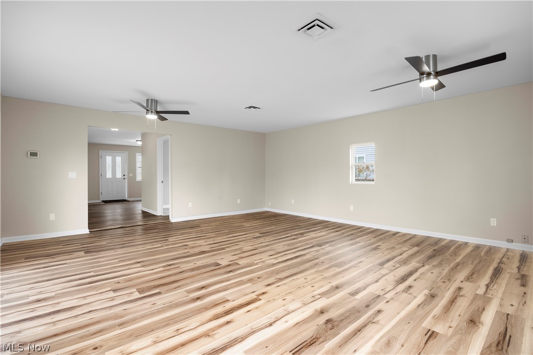 12452 Island Road Grafton, OH 44044 - Photo 12 of 39 Empty room with a ceiling fan and light wood-type flooring