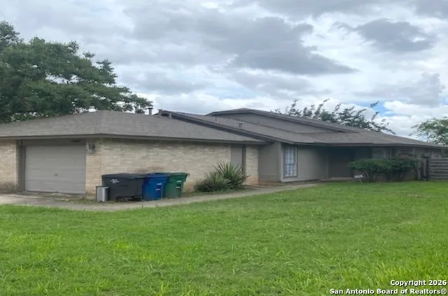 a large stone building with a yard in front of it