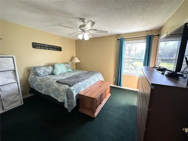 a bedroom with a bed dresser and a window