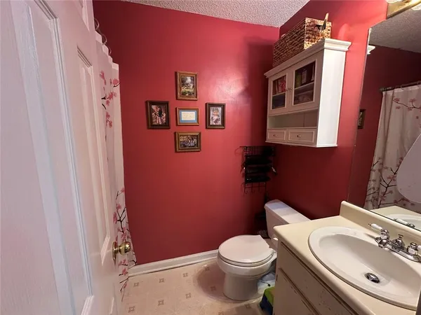 a white toilet sitting next to a bathroom sink