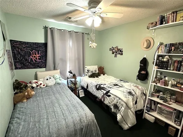 a bedroom with bed and a chandelier