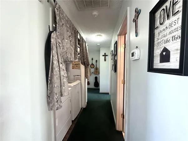 a view of a hallway with paintings on the wall